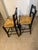 French Country-style ladder-back bar or counter stools featuring a classic wavy double-slat backrest and a hand-woven...