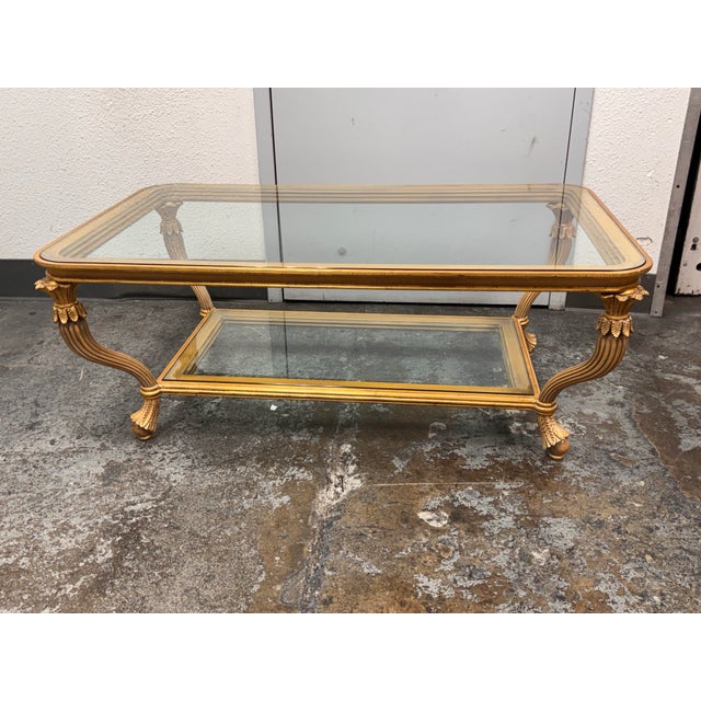 Design Plus Gallery presents a Neoclassical Italian Coffee Table from Provasi. This table showcases a gilded wooden frame...