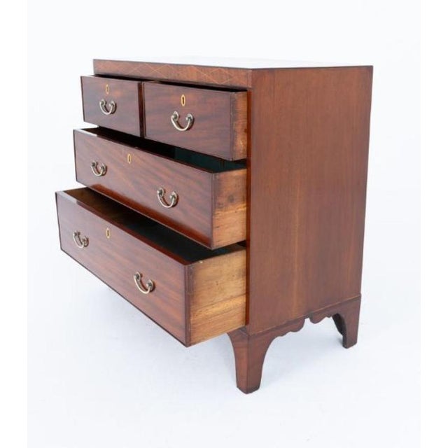 An elegant Regency mahogany chest of drawers, standing on shaped bracket feet and featuring a practical arrangement of two...