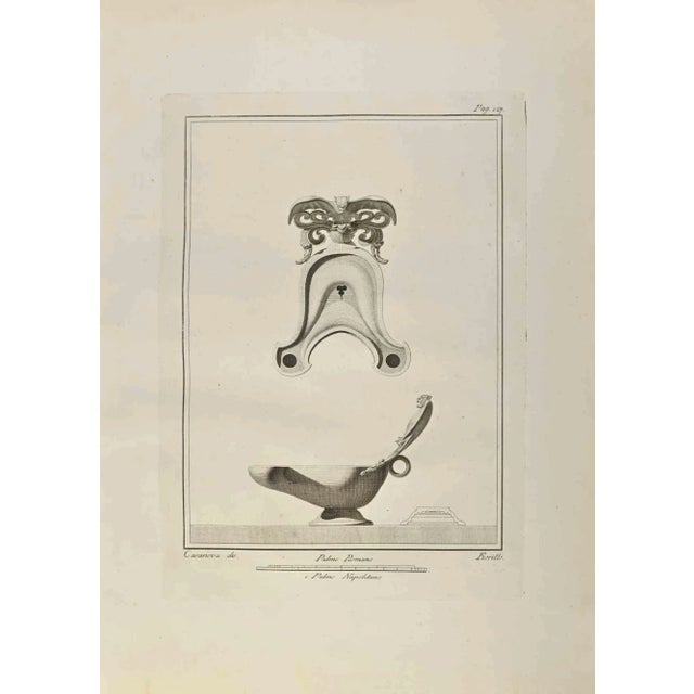 Oil Lamp with Bat from "Antiquities of Herculaneum" is an etching on paper realized by Nicola Fiorillo in the 18th...