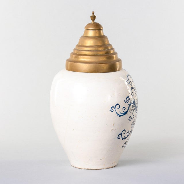 This Dutch Delft tobacco jar is of ovoid form, painted in blue and white on a tin-glazed earthenware body. The front bears...