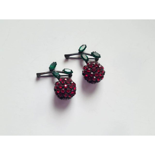 This is a two vintage rhinestone cherry brooches with green leaves from Warner, circa 1960s. Set with garnet rhinestone...