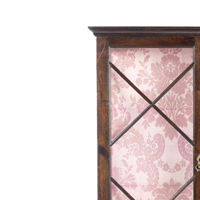 Furniture - Display case. Portuguese, 20th century; made of chestnut wood with carvings. Interior with shelves.