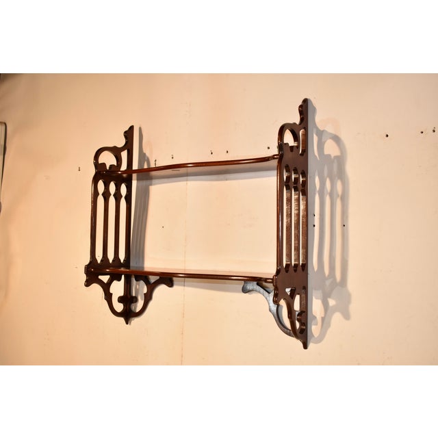 Mahogany wall shelf from England, circa 1950's. This is a great hanging shelf and in such a wonderful size! The sides of...