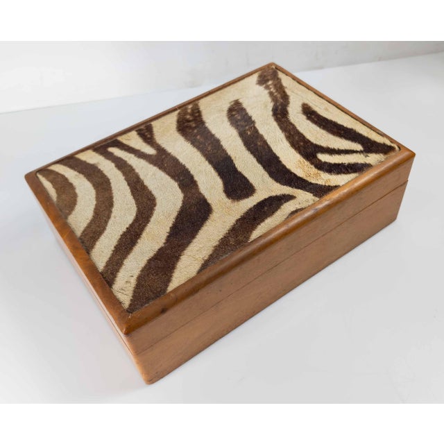 We are selling this great looking mid 20th century walnut humidor box. This humidor has authentic piece of Zebra hide on...