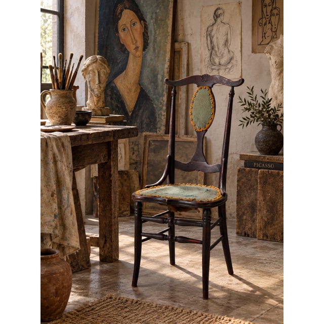 A late 19th-century Victorian side chair with an unusually elongated, sculptural silhouette. The tall open back rises to a...