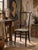 A late 19th-century Victorian side chair with an unusually elongated, sculptural silhouette. The tall open back rises to a...