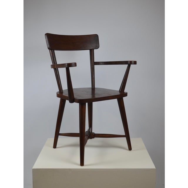 Elegant modernist wooden armchair dating from the 1940s. The chair features a beautifully balanced construction and a...
