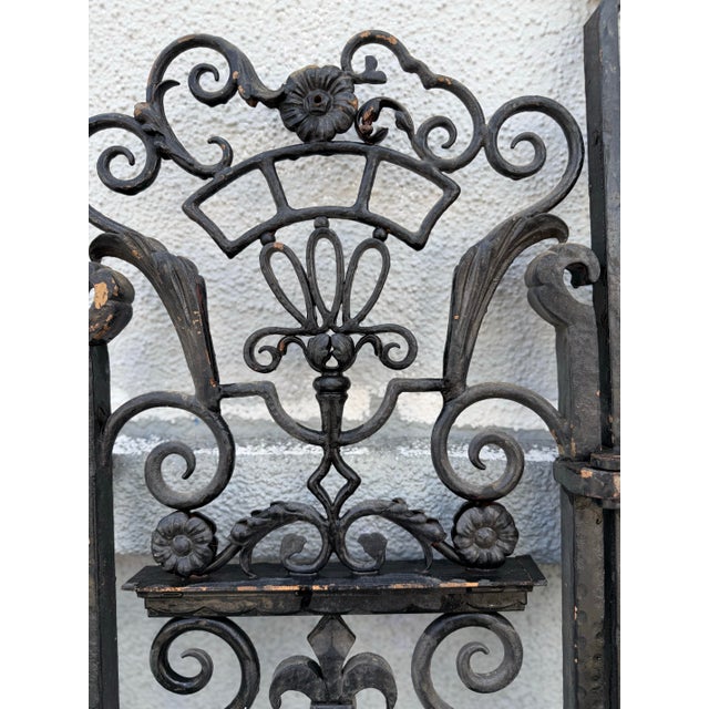 An exceptional pair of antique wrought iron architectural gates reportedly salvaged from the historic Bullocks Wilshire...