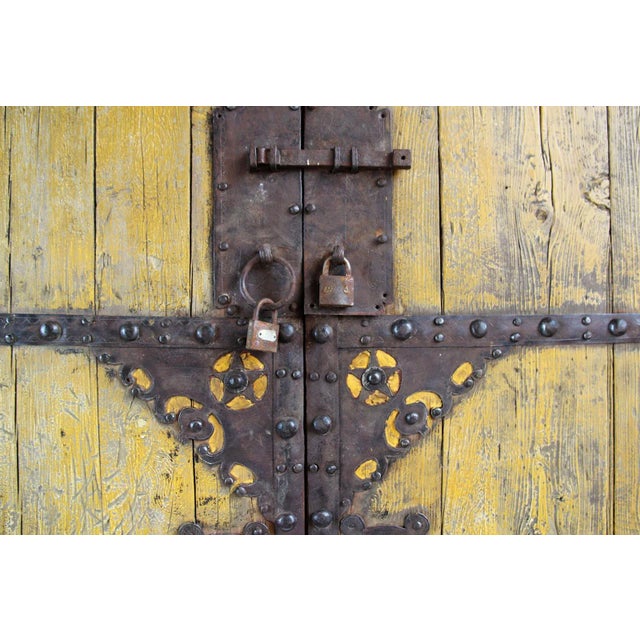 Vintage elm wood Chinese entry gate. This piece displays beautiful faded yellow patina with original iron work design...