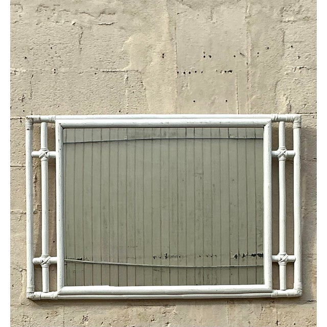 This stunning vintage rattan mirror embodies the essence of coastal charm with its intricate woven frame and airy,...