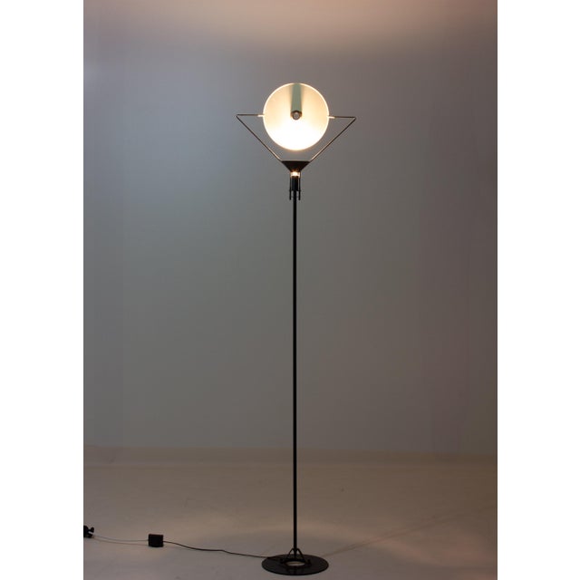 This is a Polifemo floor lamp designed by Carlo Forcolini for Artemide in the 1980s. It has a black metal frame with a...