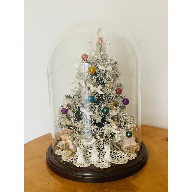 Beautiful detailed artisan made Christmas tree with angels under glass dome.