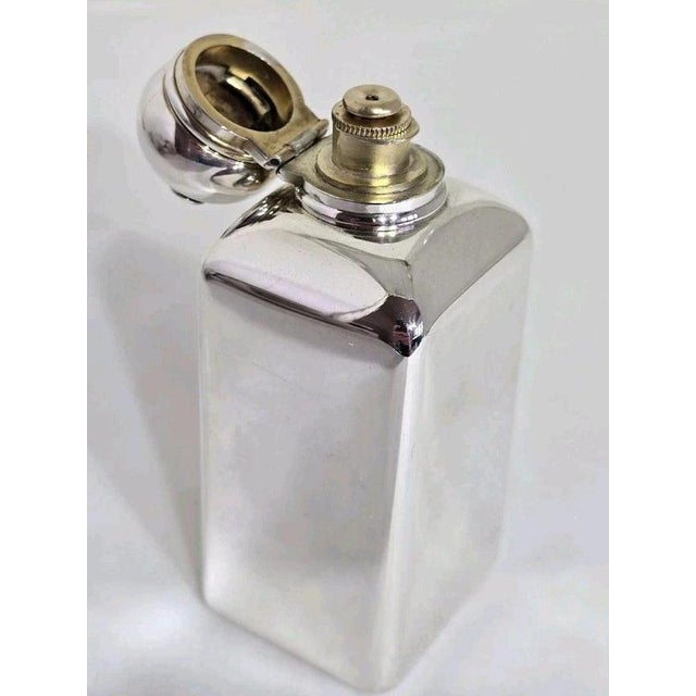 An Edwardian sterling silver and gilt scent bottle by Alfred Clark, hallmarked London 1904. Of plain rectangular form, the...