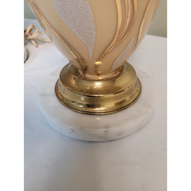 Fabulous pair of mid century hollywood regency glass and marble table lamps. Each measures 38 inches tall, with the glass...