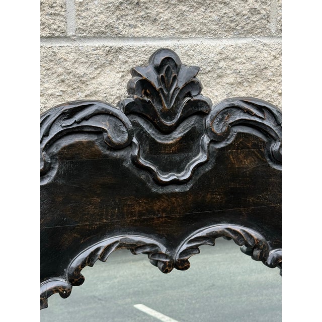 Gorgeous oversized wall mirror featuring sweeping scrolls, leafy foliate motifs, and a prominent crest at the top. Its...