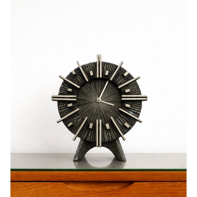 Large Brutalist table clock produced in Germany by Casper Kunstguss around 1970. A sculptural model in highly textured...