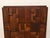 A commanding vintage highboy armoire by Lane, defined by its dimensional mosaic of stacked and staggered wood blocks...