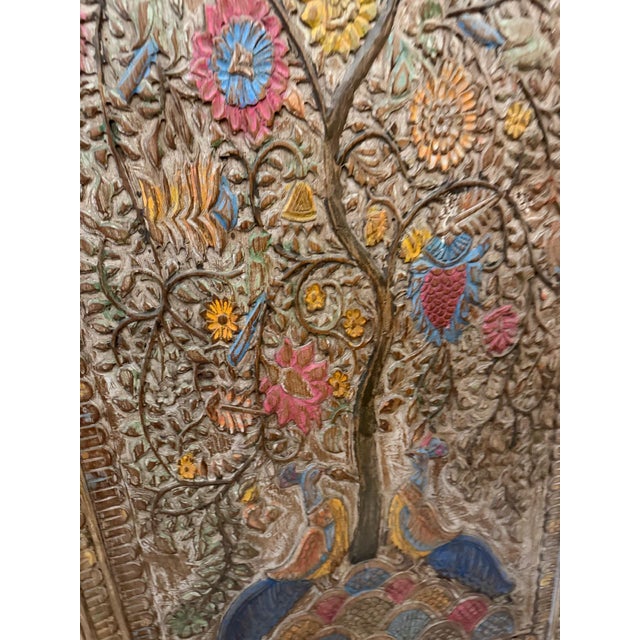 Bring timeless Indian artistry to your interiors with this hand-carved wooden wall panel, featuring an intricate Tree of...