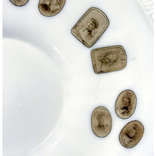 A very unusual milk glass plate which it appears was decorated post-production with a series of tiny carte-de-visite...
