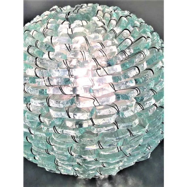 This 'Tao' lamp with glass inserts was meticulously assembled by hand, piece by piece, to give light and shape to your...
