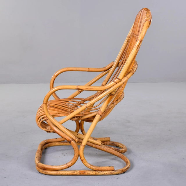 Found in Italy, this rattan armchair was designed by Tito Agnoli in 1950. Curvy and comfortable, this single chair can be...