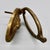 A classic English lion head door knocker in brass, with a full-maned lion set in a beaded oval frame and a hinged ring...