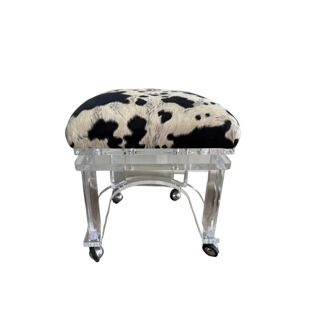 Heavy, quality lucite vanity stool on casters by Carmichael Designs of Palm Springs. Seat upholstered in an ultra-suede...