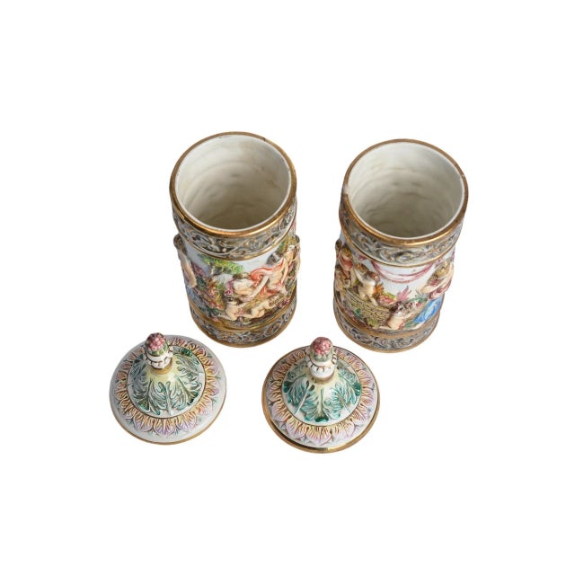 This exquisite pair of Capodimonte porcelain covered cylindrical pitcher vases, crafted in Italy circa 1930s, showcases...