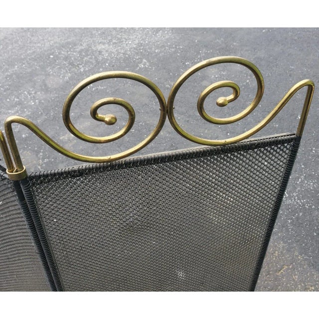 1960s Vintage Wire Mesh and Brass Ornate Fireplace Screen. Black wire mesh. Solid brass ornate. Measures 40.5" wide and...