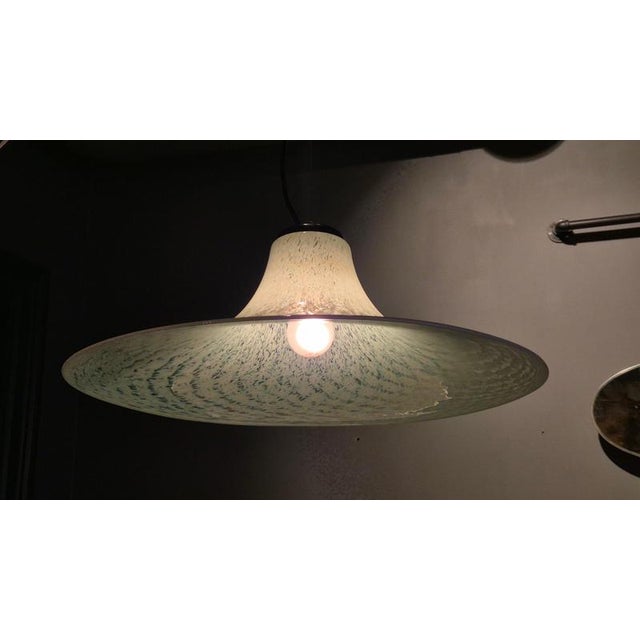 A beautiful Murano pendant in solid glass in light blue, transparent and whites, Italy 1970/80s. This pendant has been...