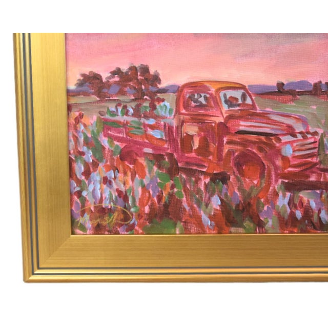 An impressionistic painting of a vintage red pickup truck parked in a wildflower field under a pink sky, set in an ornate,...