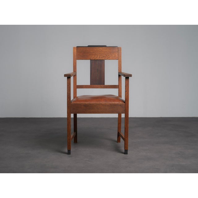 A refined pair of dutch amsterdam school art deco armchairs dating from the 1930s, characterized by their strong...