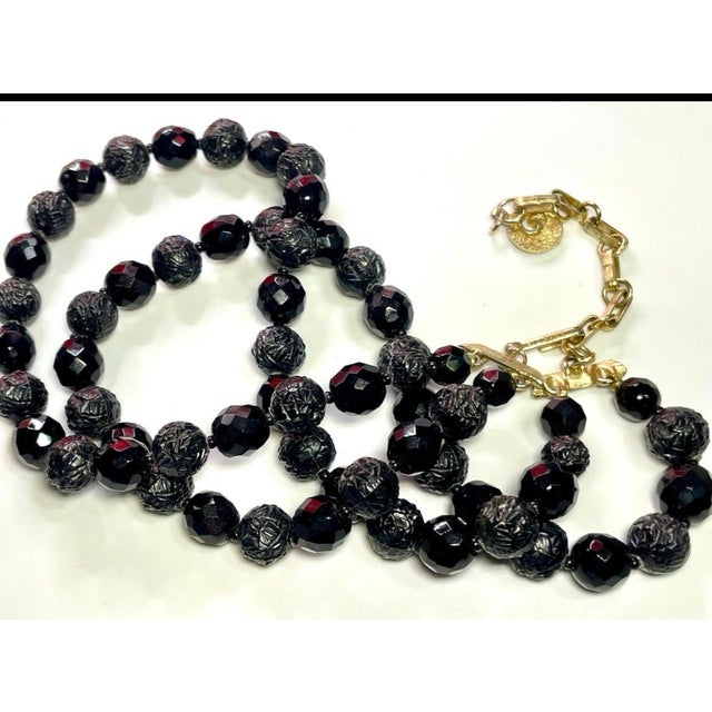 Mid century lava rock and black faux onyx, faceted glass, double strand, each strand is 16” in length. In a hook clasp....