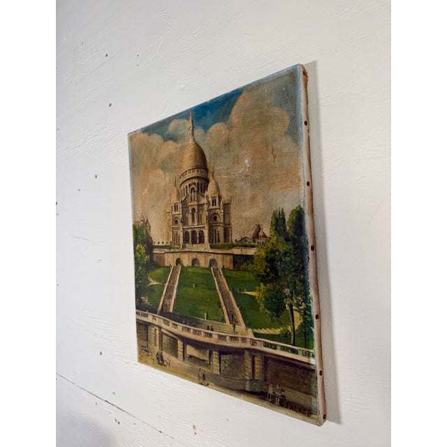Recently discovered in Paris, this antique French painting features the iconic white domed Sacré-Cœur Basilica located at...