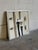 This striking canvas painting features an abstract composition depicting two figures in neutral and dark tones. Framed...