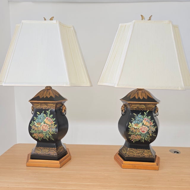 Sophisticated pair of vintage Chelsea House table lamps. Features hand-painted black tole neoclassical trophy urn...