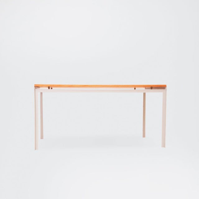 ‘Academy table’ by ​Poul Kjærholm. Grey lacquered steel frame with loose top of Oregon pine. Denmark, 1950s. This piece is...