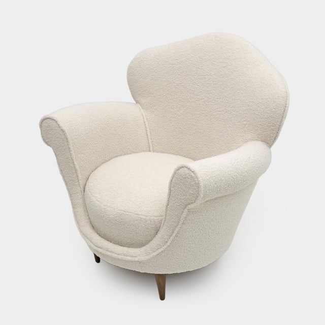 Armchair with curved backrest and rounded shape, Italian design from the 50s. The armchair has been completely renovated...