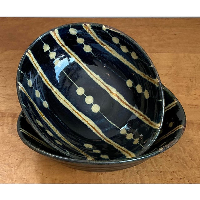 This exquisite pair of original studio pottery bowls is a striking celebration of artisan craftsmanship and graphic...