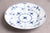 Twelve antique Royal Copenhagen flat plates, white with dark blue decoration. Stamps and details suggest they date from...