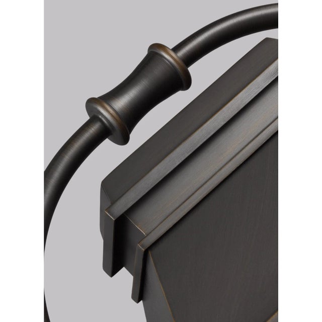 The Sean Lavin Wellsworth three light outdoor wall fixture in antique bronze creates a warm and inviting welcome...