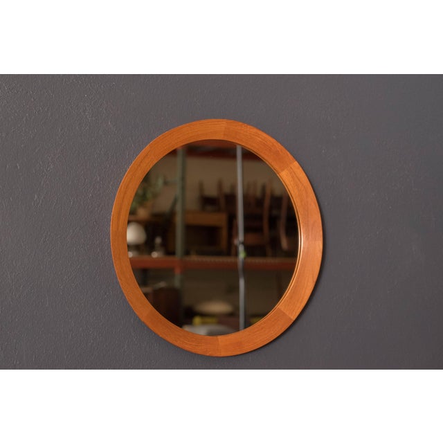Mid Century Modern round wall hanging mirror in solid teak circa 1960's, made in Denmark. This decorative accent piece...