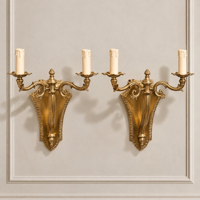Elevate a wall with the timeless elegance of this ornate two-light wall sconce, featuring a beautifully sculpted bronze...