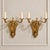 Elevate a wall with the timeless elegance of this ornate two-light wall sconce, featuring a beautifully sculpted bronze...