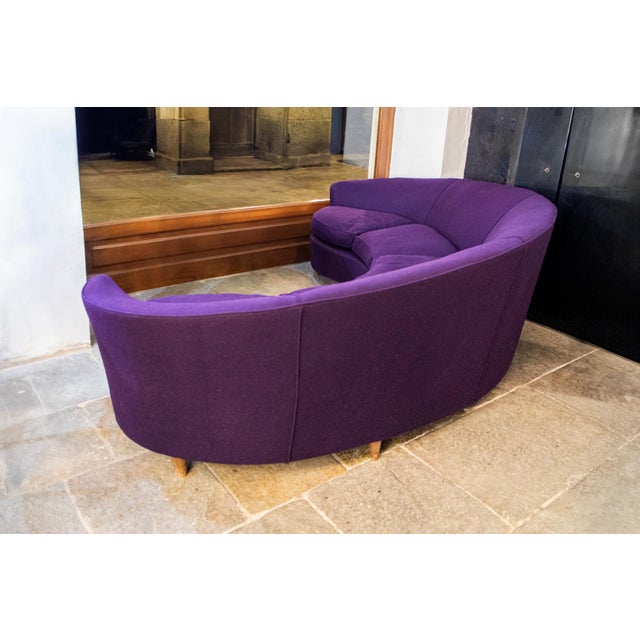 Curved sofa with fabric upholstery and wooden legs. Refurbished. Made in Italy 1950s