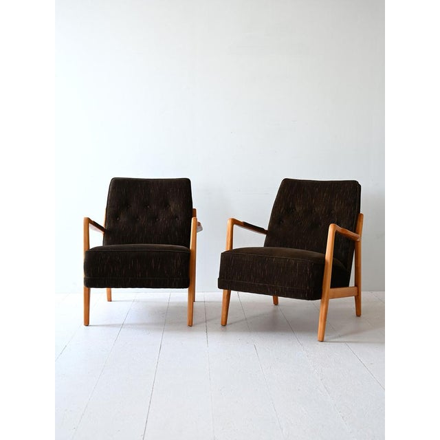 Scandinavian armchairs from the 1960s with wooden structure and armrests and seat lined with original period fabric. The...