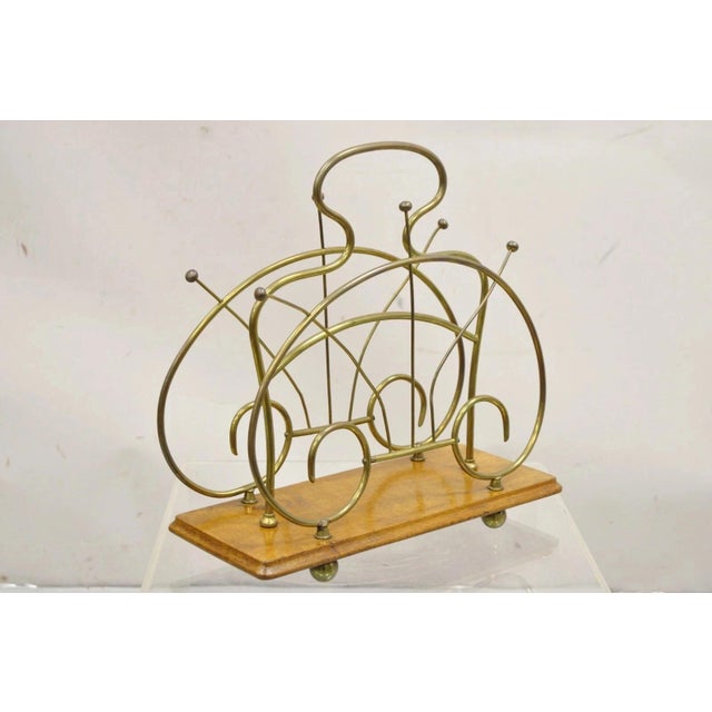Antique English Victorian Brass and Oak Wood Scrolling Magazine Rack. Circa Early 20th Century. Measurements: 15" H x...