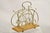 Antique English Victorian Brass and Oak Wood Scrolling Magazine Rack. Circa Early 20th Century. Measurements: 15" H x...