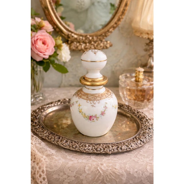 A charming antique hand-painted Nippon porcelain perfume bottle dating to the early 20th century. This petite vanity piece...